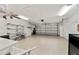 Spacious garage with ample storage, ceiling fan, and garage door at 9068 Sw 82Nd Ter # A, Ocala, FL 34481