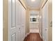 Hallway with hardwood floors and large closets, leading to a clean and brightly lit bathroom at 9068 Sw 82Nd Ter # A, Ocala, FL 34481