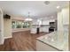 Bright kitchen with white cabinetry, stainless steel appliances, and wood-look flooring at 9068 Sw 82Nd Ter # A, Ocala, FL 34481