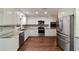 Modern kitchen featuring white cabinets, stainless steel appliances, and ample countertop space at 9068 Sw 82Nd Ter # A, Ocala, FL 34481