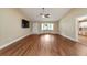 Spacious living room features wood floors, neutral paint and a large window for natural light at 9068 Sw 82Nd Ter # A, Ocala, FL 34481