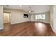 Open-concept living area with wood flooring, a bay window, and neutral paint at 9068 Sw 82Nd Ter # A, Ocala, FL 34481