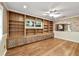Living room with custom built-in shelving and cabinets, complete with hardwood floors and natural light at 9068 Sw 82Nd Ter # A, Ocala, FL 34481