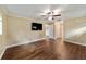 Spacious main bedroom with wood-look flooring, ceiling fan and ensuite bathroom at 9068 Sw 82Nd Ter # A, Ocala, FL 34481