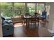 Bright sunroom dining area with a table and chairs, neutral colors, and natural lighting at 9068 Sw 82Nd Ter # A, Ocala, FL 34481