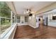 Bright sunroom with many windows, a ceiling fan, and a view of the lush backyard at 9068 Sw 82Nd Ter # A, Ocala, FL 34481