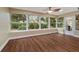 Sunroom with many windows, ceiling fan, wood-look floors, neutral colors, and natural lighting at 9068 Sw 82Nd Ter # A, Ocala, FL 34481