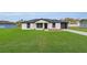 Front exterior of a single-story home with a well-manicured lawn and stone accents at 2183 Sw 3Rd St, Ocala, FL 34471