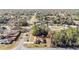 Aerial view of a home featuring a well-manicured lawn and inviting curb appeal, surrounded by lush greenery and quiet streets at 33 Pecan Pass Run, Ocala, FL 34472