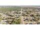Wide aerial view of a residential community featuring streets and wooded landscape at 33 Pecan Pass Run, Ocala, FL 34472