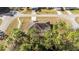A view of a single-Gathering home, featuring a driveway and surrounded by trees, nestled in a quiet residential area at 33 Pecan Pass Run, Ocala, FL 34472