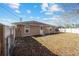 Fenced backyard with a clothesline, offering a private outdoor space at 33 Pecan Pass Run, Ocala, FL 34472