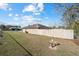 Side view of a single-story home showing partial fencing and grassy backyard at 33 Pecan Pass Run, Ocala, FL 34472