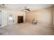 Bedroom with two windows, ceiling fan, dresser and doorway to ensuite at 33 Pecan Pass Run, Ocala, FL 34472