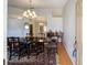 A dining room with a large table, chandelier, and a decorative rug at 33 Pecan Pass Run, Ocala, FL 34472