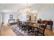 Bright dining room with a large table, chandelier, decorative rug, and adjacent rooms at 33 Pecan Pass Run, Ocala, FL 34472
