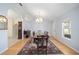 Dining room featuring a large table, chandelier, and decorative rug at 33 Pecan Pass Run, Ocala, FL 34472