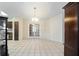 Spacious dining room features tile floors, elegant lighting, and doors leading to another room at 33 Pecan Pass Run, Ocala, FL 34472