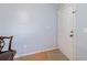 An entryway with light blue walls, a white door, and wood-look flooring at 33 Pecan Pass Run, Ocala, FL 34472