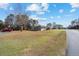 Single story home with a large front yard and well-maintained landscaping, providing a welcoming curb appeal at 33 Pecan Pass Run, Ocala, FL 34472