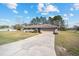 Well-maintained single-story home with a long driveway and a manicured front lawn in a quiet neighborhood at 33 Pecan Pass Run, Ocala, FL 34472