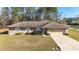 Charming single-story home featuring an attached garage and well-maintained lawn at 33 Pecan Pass Run, Ocala, FL 34472
