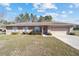 Inviting single-story home with a two-car garage, trimmed hedges, and a neatly kept front yard at 33 Pecan Pass Run, Ocala, FL 34472