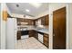 Functional kitchen features wooden cabinets, white appliances, and a skylight for natural lighting at 33 Pecan Pass Run, Ocala, FL 34472