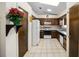 Functional kitchen features wooden cabinets, white appliances, and a skylight for natural lighting at 33 Pecan Pass Run, Ocala, FL 34472