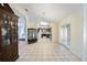 Open living area with tile flooring, a large archway, and a view into the kitchen with dark cabinets at 33 Pecan Pass Run, Ocala, FL 34472