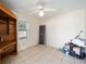 Bright living room features tile flooring, a ceiling fan, and a built-in wooden cabinet at 33 Pecan Pass Run, Ocala, FL 34472