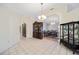 Open-concept living space with tile flooring, dark wood furnishings, and access to multiple rooms at 33 Pecan Pass Run, Ocala, FL 34472