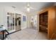 Bright living room featuring tile flooring, a ceiling fan, built in desk, and french doors at 33 Pecan Pass Run, Ocala, FL 34472