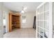 Bright living room features tile flooring, a ceiling fan, and a built-in wooden cabinet at 33 Pecan Pass Run, Ocala, FL 34472