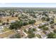 Aerial view of a suburban neighborhood with houses surrounded by lush greenery and well-manicured lawns at 4535 Se 32Nd Pl, Ocala, FL 34480