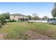 Large backyard with a white fence and mature trees, creating a private outdoor space at 4535 Se 32Nd Pl, Ocala, FL 34480