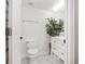 Bright bathroom featuring marble floors, plant accent, modern fixtures, and an open doorway at 4535 Se 32Nd Pl, Ocala, FL 34480
