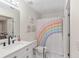 Cheerful bathroom featuring rainbow shower curtain, vanity, and cute wall decor at 4535 Se 32Nd Pl, Ocala, FL 34480