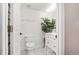 Small, well-lit bathroom with white fixtures and a decorative houseplant at 4535 Se 32Nd Pl, Ocala, FL 34480