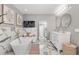 Luxurious bathroom featuring a soaking tub, marble floors, and double vanity at 4535 Se 32Nd Pl, Ocala, FL 34480