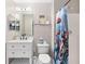 This charming bathroom features a new vanity, mirror, and themed shower curtain at 4535 Se 32Nd Pl, Ocala, FL 34480