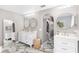 Elegant bathroom featuring double vanity, gold fixtures, arched doorway, and marble floors at 4535 Se 32Nd Pl, Ocala, FL 34480