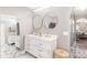 Bright primary bathroom with a double sink vanity, marble tile, and modern fixtures at 4535 Se 32Nd Pl, Ocala, FL 34480