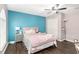 Comfortable bedroom with blue accent wall, ceiling fan, and large closet at 4535 Se 32Nd Pl, Ocala, FL 34480