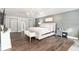 A large bedroom that includes an accent wall, chandelier, and plenty of natural light at 4535 Se 32Nd Pl, Ocala, FL 34480
