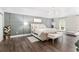 Spacious bedroom features a modern chandelier, accent wall and dark wood flooring at 4535 Se 32Nd Pl, Ocala, FL 34480