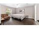 Bright bedroom with a queen-sized bed, wood floors, and natural lighting at 4535 Se 32Nd Pl, Ocala, FL 34480