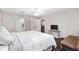 Comfortable bedroom features a bed, natural light, wood-look flooring and a small couch at 4535 Se 32Nd Pl, Ocala, FL 34480