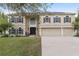 Charming two-story home with a three-car garage, neutral paint, solar panels and well-manicured lawn at 4535 Se 32Nd Pl, Ocala, FL 34480