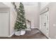 Bright foyer with hardwood floors and a festive Christmas tree at 4535 Se 32Nd Pl, Ocala, FL 34480
